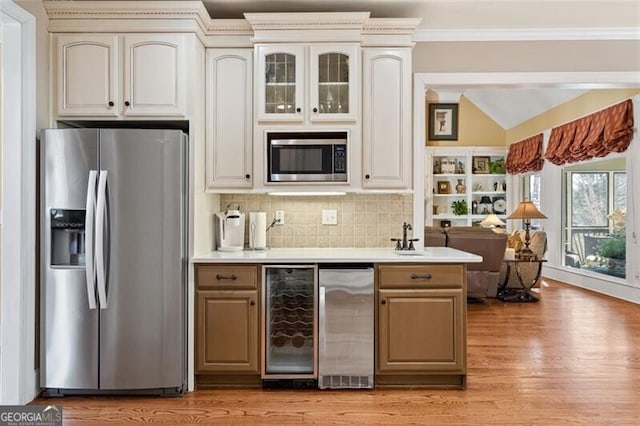 4115 Gold Mill Rdg, Canton, GA 30114 - kitchen with stainless steel appliances, beverage cooler, crown molding, light wood-style flooring, and light countertops