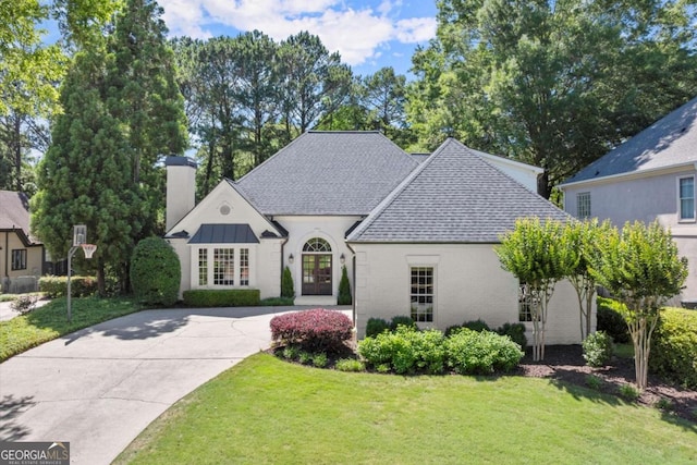 5120 Falcon Chase Ln, Atlanta, GA 30342 - french country inspired facade with french doors, a front lawn, a chimney, and a shingled roof