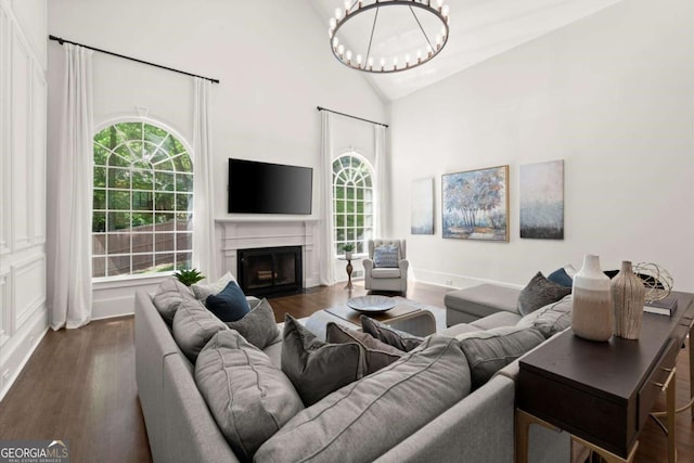 5120 Falcon Chase Ln, Atlanta, GA 30342 - living room with wood finished floors, plenty of natural light, a fireplace with flush hearth, a chandelier, and high vaulted ceiling