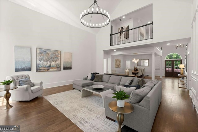 5120 Falcon Chase Ln, Atlanta, GA 30342 - living room featuring a chandelier, wood finished floors, high vaulted ceiling, baseboards, and recessed lighting