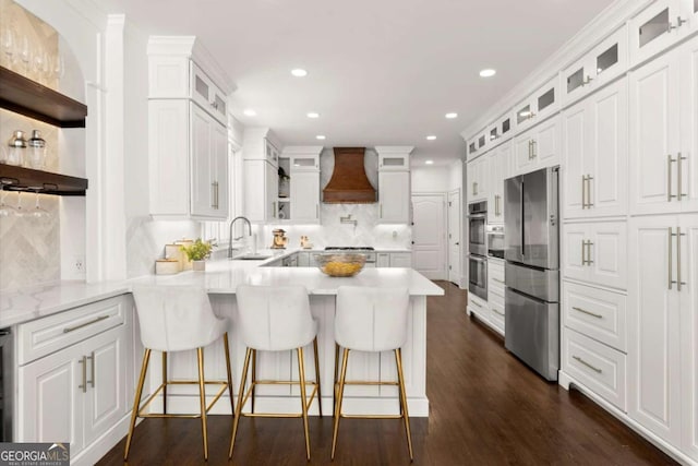 5120 Falcon Chase Ln, Atlanta, GA 30342 - kitchen featuring appliances with stainless steel finishes, premium range hood, a sink, a peninsula, and open shelves