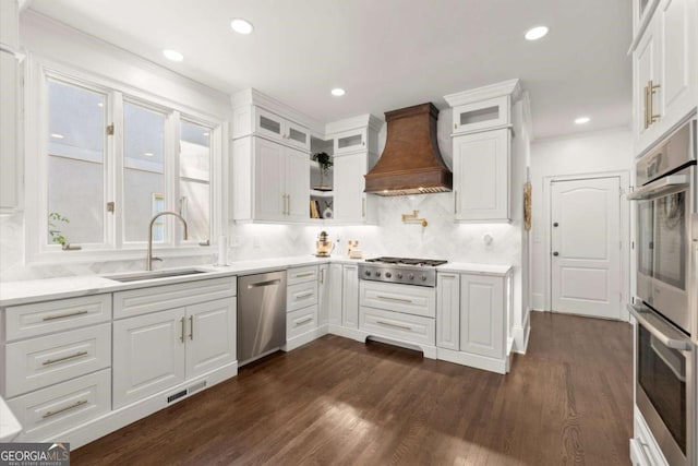 5120 Falcon Chase Ln, Atlanta, GA 30342 - kitchen with stainless steel appliances, custom range hood, a sink, white cabinetry, and recessed lighting