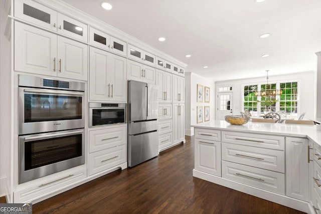 5120 Falcon Chase Ln, Atlanta, GA 30342 - kitchen with appliances with stainless steel finishes, dark wood-style floors, white cabinetry, recessed lighting, and light countertops