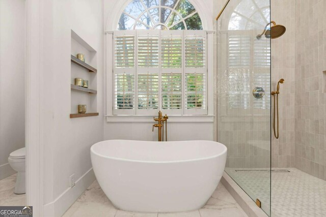 5120 Falcon Chase Ln, Atlanta, GA 30342 - bathroom with marble look tile flooring, a freestanding bath, tiled shower, and toilet