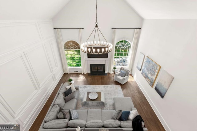 5120 Falcon Chase Ln, Atlanta, GA 30342 - living room with a chandelier, dark wood finished floors, plenty of natural light, a fireplace, and high vaulted ceiling