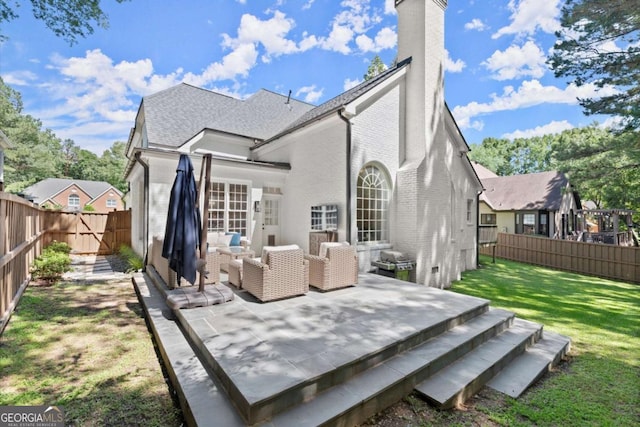 5120 Falcon Chase Ln, Atlanta, GA 30342 - back of house featuring brick siding, an outdoor living space, a chimney, and a wooden deck