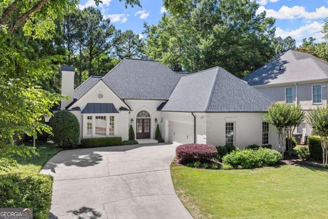 5120 Falcon Chase Ln, Atlanta, GA 30342 - french country home with french doors, a chimney, a front yard, driveway, and an attached garage