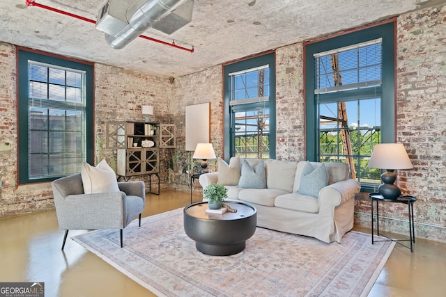 170 Boulevard E414, Atlanta, GA 30312 - living room featuring healthy amount of natural light, finished concrete floors, and brick wall