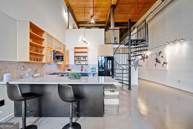 170 Boulevard E414, Atlanta, GA 30312 - kitchen featuring stainless steel appliances, open shelves, wooden ceiling, a peninsula, and finished concrete floors