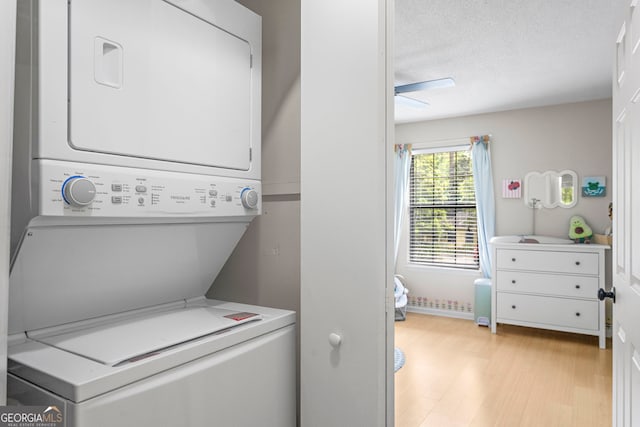 39 Helmsman Ct, Savannah, GA 31410 - washroom with stacked washer / dryer, light wood-style flooring, a ceiling fan, and a textured ceiling