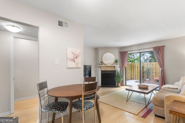 39 Helmsman Ct, Savannah, GA 31410 - dining area featuring a fireplace with flush hearth and light wood-style flooring