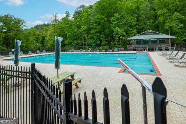 44 11th St, Ellijay, GA 30540 - community pool featuring a patio area and a view of trees