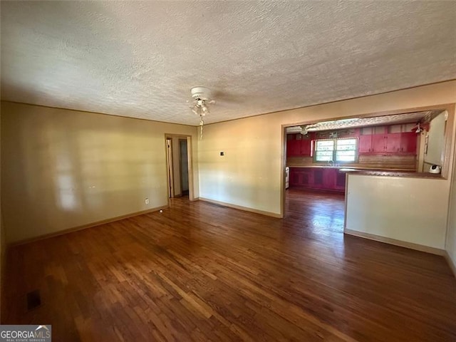 1272 Cave Springs Rd, Douglasville, GA 30134 - unfurnished room featuring dark wood-style flooring, a textured ceiling, and baseboards