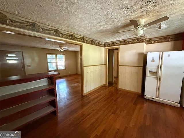 1272 Cave Springs Rd, Douglasville, GA 30134 - kitchen featuring white refrigerator with ice dispenser, ceiling fan, a textured ceiling, a wainscoted wall, and dark wood-style flooring