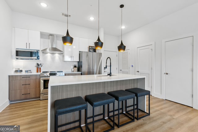 112 Rogers St NE Unit 410, Atlanta, GA 30317 - kitchen with appliances with stainless steel finishes, wall chimney exhaust hood, a sink, modern cabinets, and white cabinets
