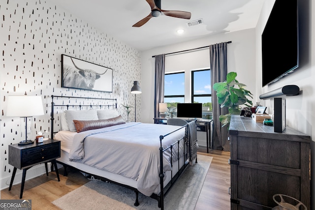 112 Rogers St NE Unit 410, Atlanta, GA 30317 - bedroom featuring wallpapered walls, an accent wall, light wood-style flooring, a ceiling fan, and recessed lighting