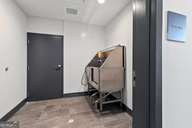 112 Rogers St NE Unit 410, Atlanta, GA 30317 - misc room with pet washing area, a drop ceiling, and baseboards