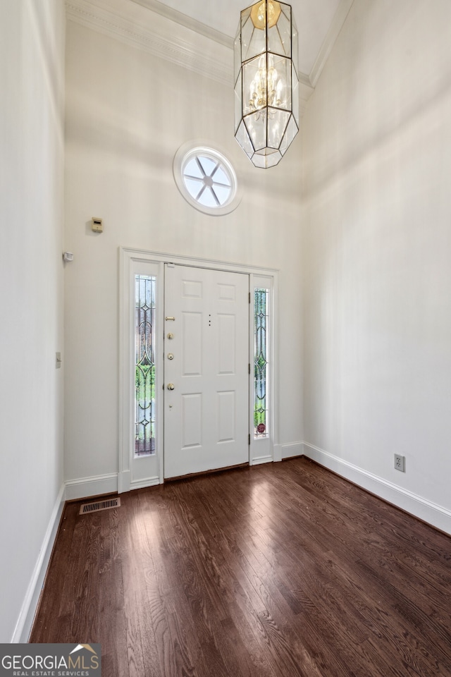 51 Ivy Chase NE, Atlanta, GA 30342 - foyer entrance featuring crown molding, a chandelier, wood finished floors, and a towering ceiling