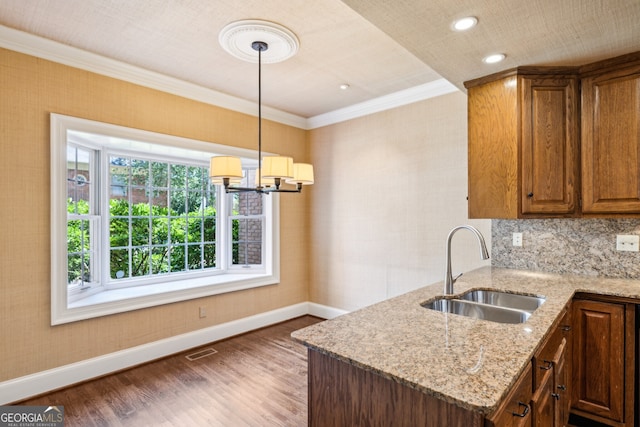 51 Ivy Chase NE, Atlanta, GA 30342 - kitchen with wood finished floors, a chandelier, crown molding, light stone countertops, and pendant lighting