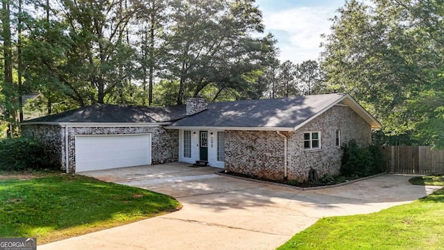 299 Kennington Dr, Athens, GA 30606 - ranch-style home with concrete driveway, a garage, and a chimney