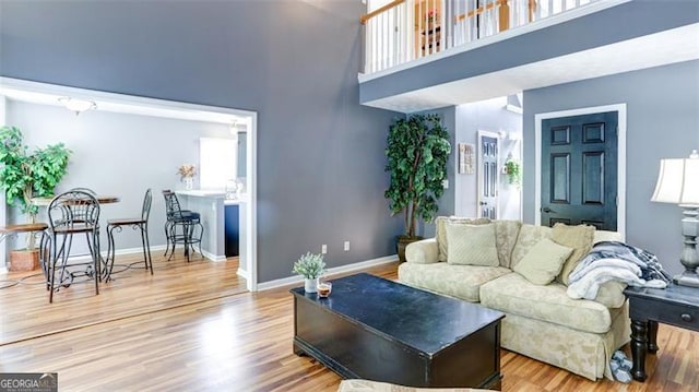 118 Valleyside Dr, Dallas, GA 30157 - living room with a towering ceiling, wood finished floors, baseboards, and healthy amount of natural light