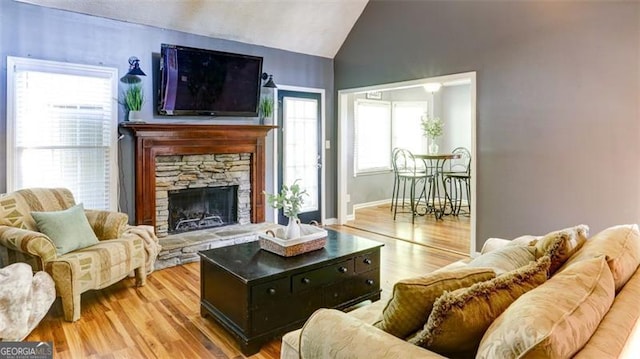 118 Valleyside Dr, Dallas, GA 30157 - living area with vaulted ceiling, wood finished floors, and a fireplace