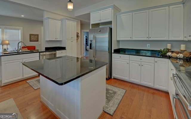 276 E Tugalo St, Toccoa, GA 30577 - kitchen featuring appliances with stainless steel finishes, white cabinets, light wood-type flooring, recessed lighting, and a center island