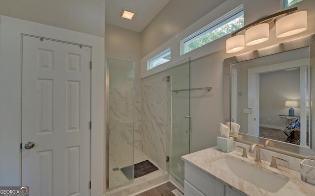 276 E Tugalo St, Toccoa, GA 30577 - bathroom featuring a marble finish shower, vanity, and wood finished floors