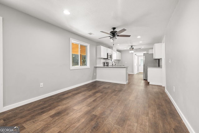 1935 Sam Bell Rd, Clarkesville, GA 30523 - unfurnished living room featuring a ceiling fan, recessed lighting, dark wood-style floors, baseboards, and a sink
