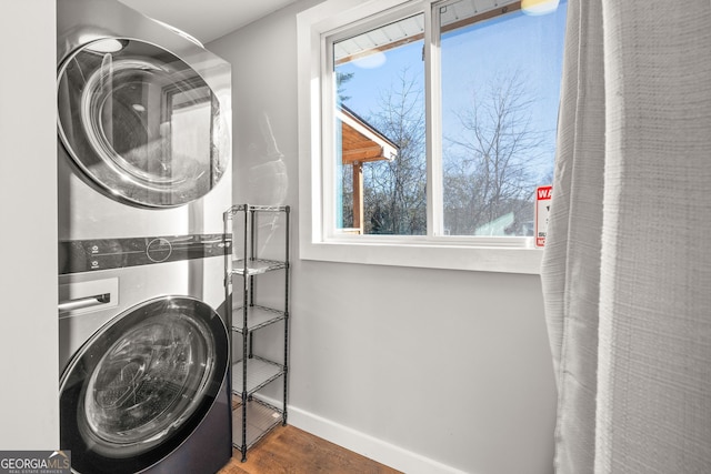 1935 Sam Bell Rd, Clarkesville, GA 30523 - washroom featuring stacked washer / dryer, wood finished floors, and baseboards