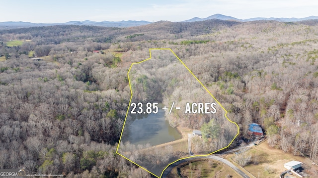 1935 Sam Bell Rd, Clarkesville, GA 30523 - aerial view of property and surrounding area with a heavily wooded area, property boundaries highlighted, and mountains