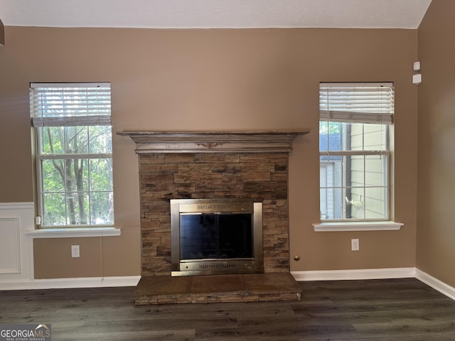 1280 Waterwood Dr, Loganville, GA 30052 - unfurnished living room featuring wood finished floors, a fireplace, and baseboards