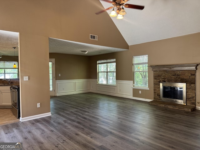 1280 Waterwood Dr, Loganville, GA 30052 - unfurnished living room featuring high vaulted ceiling, a ceiling fan, wood finished floors, a wainscoted wall, and a sink