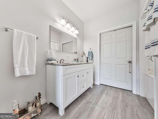 3931 Upper Bethany Rd, Ball Ground, GA 30107 - bathroom featuring double vanity and wood finished floors