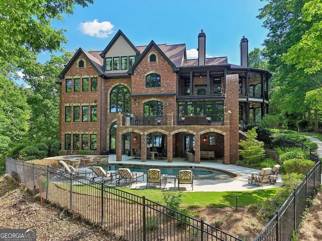 6678 Gaines Ferry Rd, Flowery Branch, GA 30542 - rear view of house featuring a balcony, a fenced backyard, an outdoor living space, a patio, and brick siding