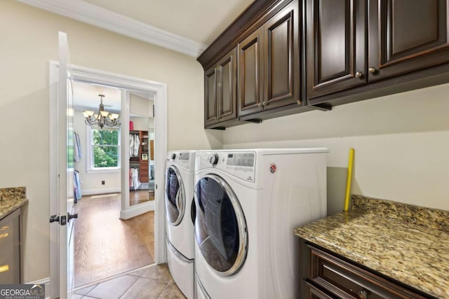 6678 Gaines Ferry Rd, Flowery Branch, GA 30542 - laundry room with cabinet space, separate washer and dryer, a chandelier, crown molding, and light tile patterned flooring