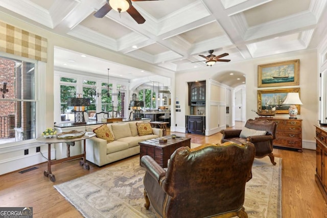 6678 Gaines Ferry Rd, Flowery Branch, GA 30542 - living room featuring a ceiling fan, arched walkways, beamed ceiling, coffered ceiling, and light wood finished floors