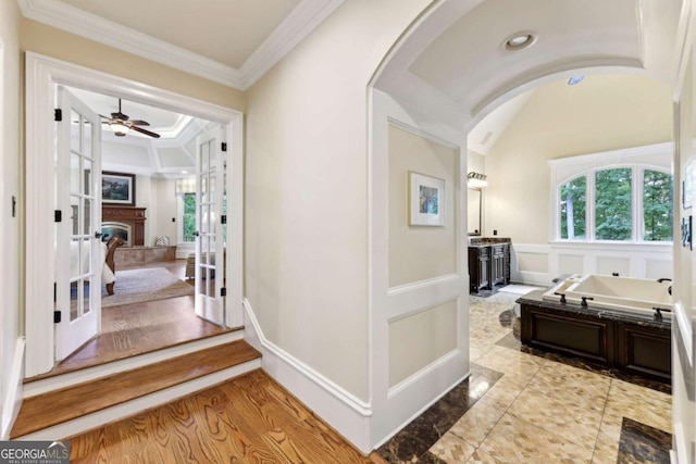 6678 Gaines Ferry Rd, Flowery Branch, GA 30542 - hallway with arched walkways, ornamental molding, a decorative wall, and french doors