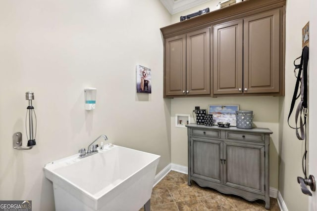 6678 Gaines Ferry Rd, Flowery Branch, GA 30542 - laundry area with washer hookup, cabinet space, and ornamental molding