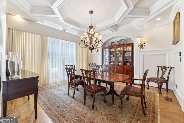 6678 Gaines Ferry Rd, Flowery Branch, GA 30542 - dining area with a chandelier, coffered ceiling, crown molding, light wood-style floors, and beamed ceiling