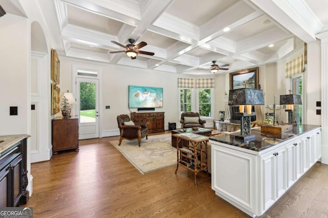 6678 Gaines Ferry Rd, Flowery Branch, GA 30542 - kitchen featuring ceiling fan, wood finished floors, dark stone counters, beamed ceiling, and open floor plan