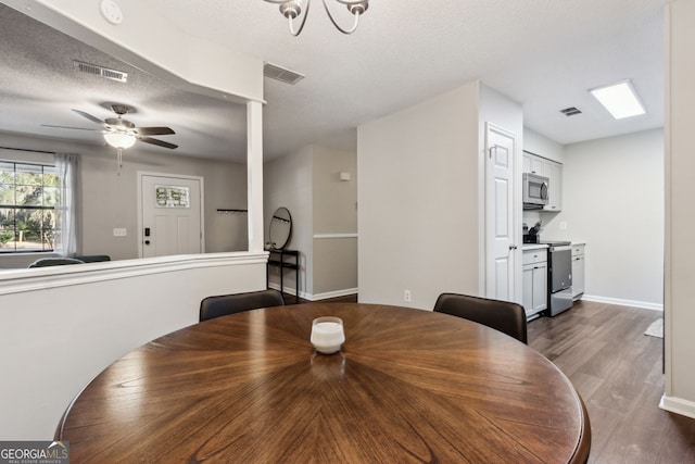 400 Dandy St, Saint Marys, GA 31558 - dining space featuring dark wood-type flooring, a textured ceiling, a ceiling fan, and baseboards