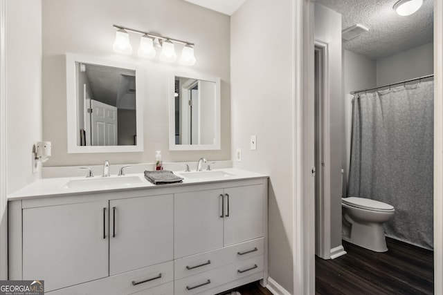 400 Dandy St, Saint Marys, GA 31558 - full bathroom featuring wood finished floors, double vanity, toilet, and a textured ceiling