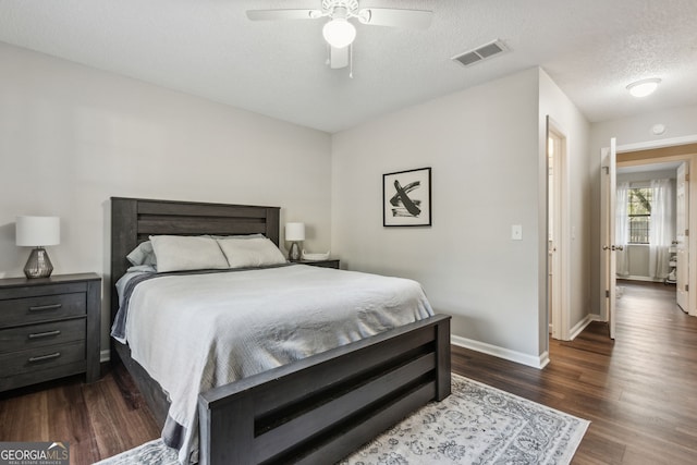 400 Dandy St, Saint Marys, GA 31558 - bedroom featuring dark wood-style floors, baseboards, a textured ceiling, and a ceiling fan