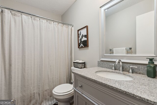 400 Dandy St, Saint Marys, GA 31558 - bathroom featuring a textured ceiling, toilet, vanity, and a shower with curtain