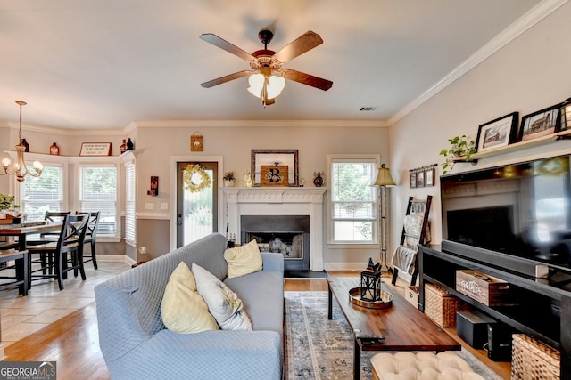 2469 Martini Way, Bethlehem, GA 30620 - living area with a fireplace, a ceiling fan, a chandelier, baseboards, and crown molding