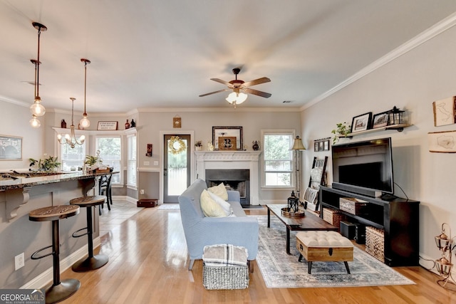 2469 Martini Way, Bethlehem, GA 30620 - living area with plenty of natural light, a ceiling fan, light wood finished floors, and ornamental molding
