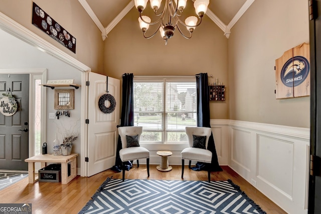 2469 Martini Way, Bethlehem, GA 30620 - sitting room with a chandelier, light wood-style floors, ornamental molding, high vaulted ceiling, and wainscoting