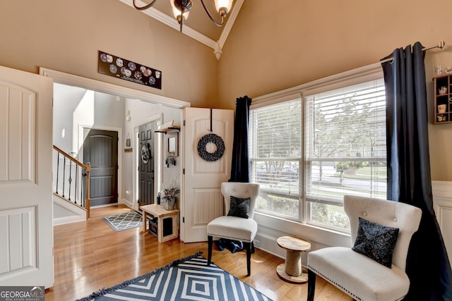 2469 Martini Way, Bethlehem, GA 30620 - living area featuring ornamental molding, high vaulted ceiling, wood finished floors, a chandelier, and stairway
