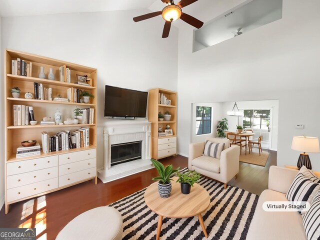 1503 Colt Ridge Ln SE, Mableton, GA 30126 - living area featuring a ceiling fan, wood finished floors, a glass covered fireplace, and high vaulted ceiling